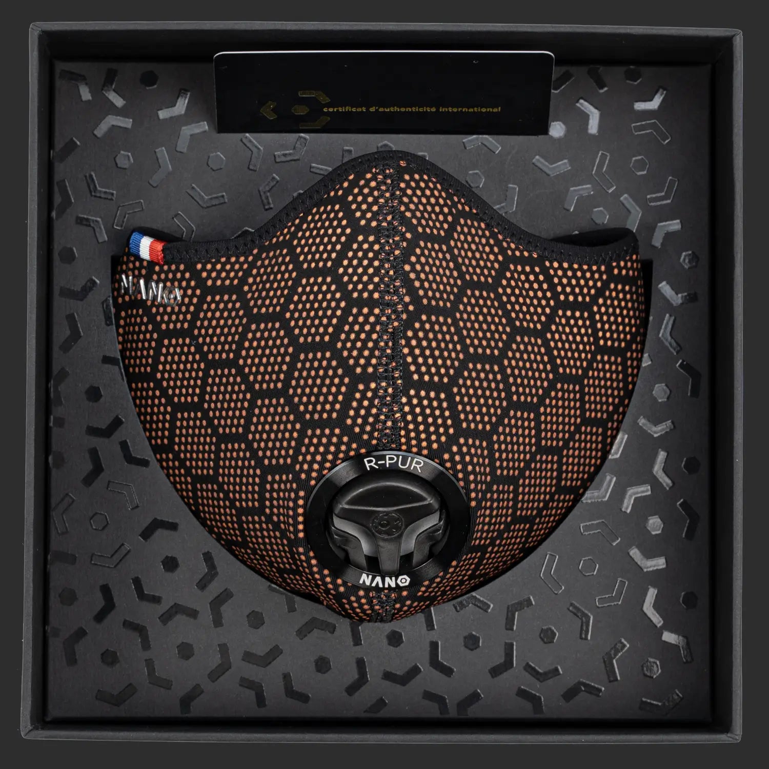 R-PUR orange mask presented inside its black box with certificate card and hex-pattern lining.