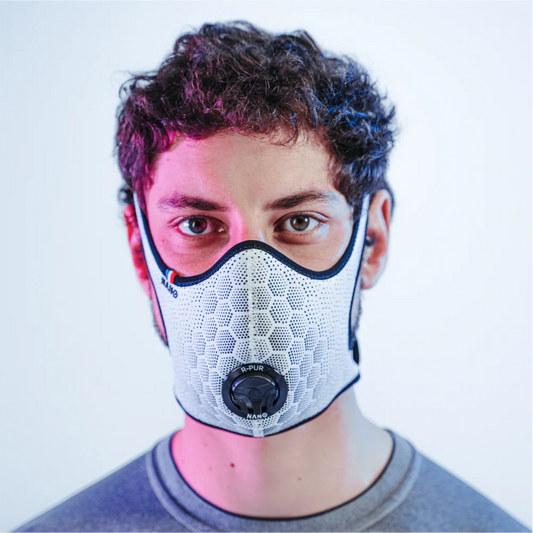 Runner wearing a white R-PUR running mask looking straight ahead