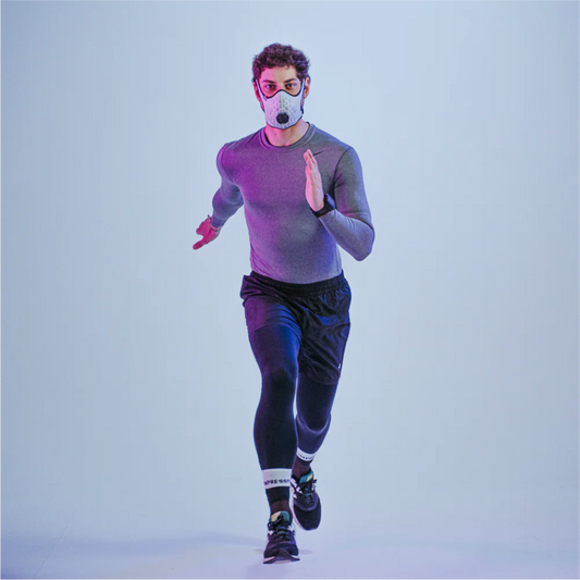Runner wearing a white R-PUR running mask looking straight ahead and running toward the camera